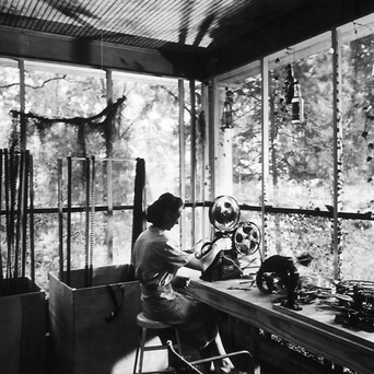 Arnold Eagle, Louisiana Story editor Helen van Dongen operating a Moviola on the porch of the house rented by the Flaherty company, Abbeville, LA, c. 1947. Courtesy of Standard Oil of New Jersey Collection, Special Collections, University of Louisville.