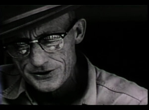 Closeup of Roscoe Holcomb playing guitar from The Highe Lonesome Sound