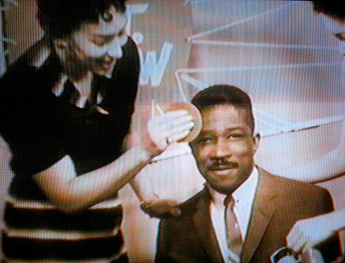 Production assistants help Mitch Thomas prepare for The Mitch Thomas Show, Wilmington, Delaware, ca. 1955. Screenshot from Black Philadelphia Memories, directed by Trudi Brown (WHYY-TV12, 1999). Screenshot courtesy of Matthew F. Delmont.