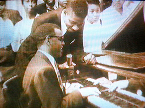 Mitch Thomas (center with microphone) interviews Ray Charles as teens look on, Wilmington, Delaware, ca. 1956. Screenshot from Black Philadelphia Memories, directed by Trudi Brown (WHYY-TV12, 1999). Screenshot courtesy of Matthew F. Delmont, The Nicest Kids in Town.