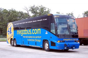 A parked blue coach bus. On the side reads "megabus.com. low-cost express bus service to and from Chicago"