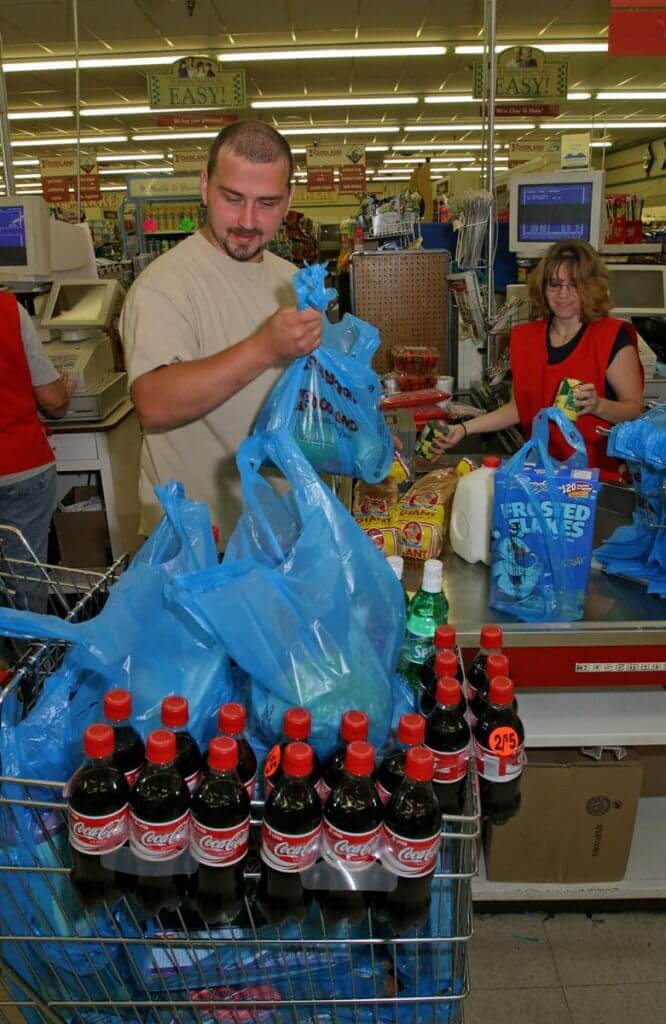 Coal miner buys groceries for his family at Buffalo Creek Supermarket. Logan County, WV, 2005.