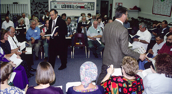 Laurie Sommers, Clarke Lee (left) and David I. Lee walk time at the 2001 All-Day Sing, Hoboken, Georgia.