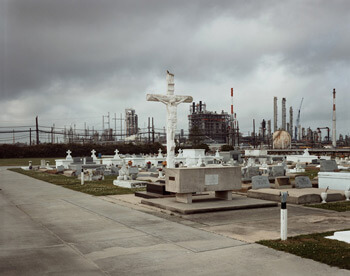Richard Misrach, Holy Rosary Cemetery and Dow Chemical Corporation (Union Carbide Complex), Taft, Louisiana, 1998 from Petrochemical America, photographs by Richard Misrach, Ecological Atlas by Kate Orff (Aperture, 2012). © Richard Misrach, courtesy of Pace/MacGill Gallery, New York; Fraenkel Gallery, San Francisco; and Marc Selwyn Gallery, Los Angeles. Richard Misrach, Holy Rosary Cemetery and Dow Chemical Corporation (Union Carbide Complex), Taft, Louisiana, 1998 from Petrochemical America, photographs by Richard Misrach, Ecological Atlas by Kate Orff (Aperture, 2012). © Richard Misrach, courtesy of Pace/MacGill Gallery, New York; Fraenkel Gallery, San Francisco; and Marc Selwyn Gallery, Los Angeles.