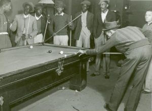Shooting pool on a Saturday afternoon, Clarksdale, Mississippi Delta, Mississippi, November 1939. Photograph by Marion Post Wolcott. Courtesy of The New York Public Library, Schomburg Center for Research in Black Culture, Photographs and Prints Division, digitalcollections.nypl.org/items/510d47df-f8dc-a3d9-e040-e00a18064a99.