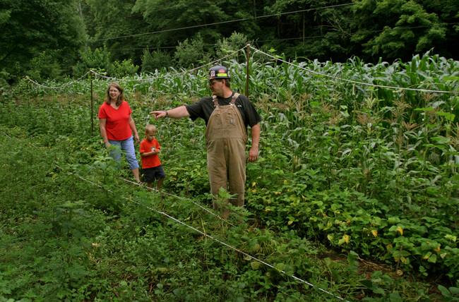 Surface miner in home garden in Logan County, WV with wife and godson before the miner's afternoon shift, 2006.