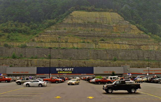 Walmart, situated in a shopping center several miles from downtown Logan on a strip mine bench. In a state once dominated by coal production, Walmart has become West Virginia's largest employer. Logan County, WV, 2005.