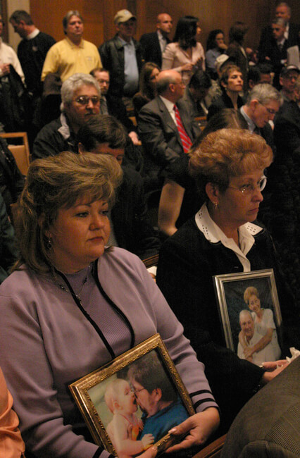 Coal miners' widows hold portraits of their husbands at United States Senate Coal Miners Safety Hearing on March 2, 2006. Forty-seven US miners died in 2006. Washington, DC.