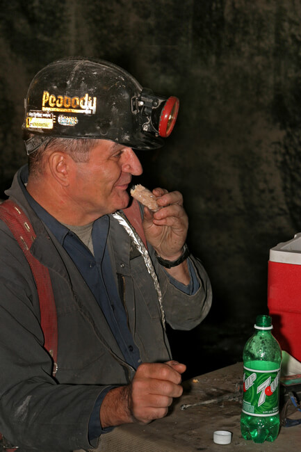 Deep miner takes his mid-shift meal at the miner's dinner hole. Boone County, WV, 2005.