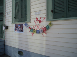 Dorothy Moye, Bywater neighborhood, Tibetan prayer flags and poster with preserved code, 2009.