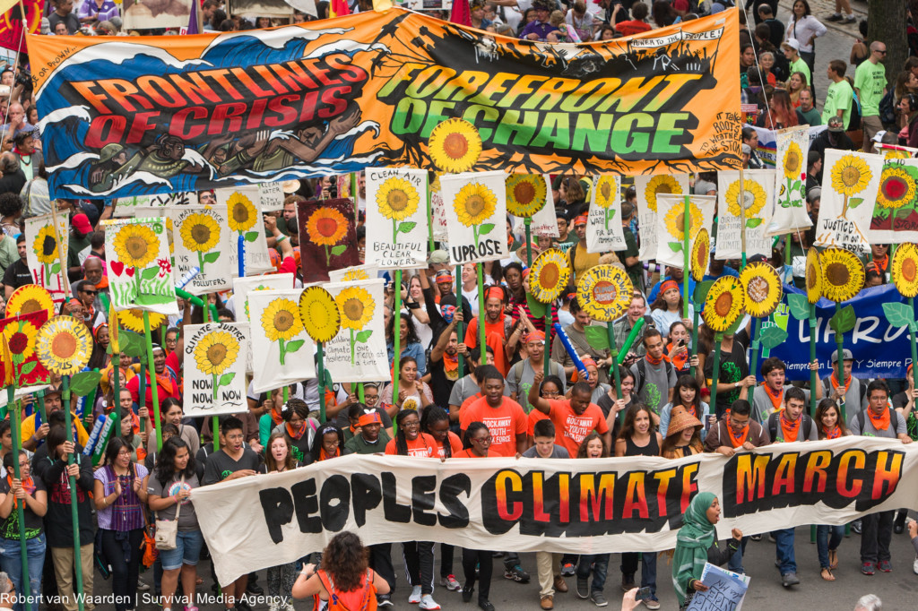 Many people carrying signs and banners in Peoples Climate March