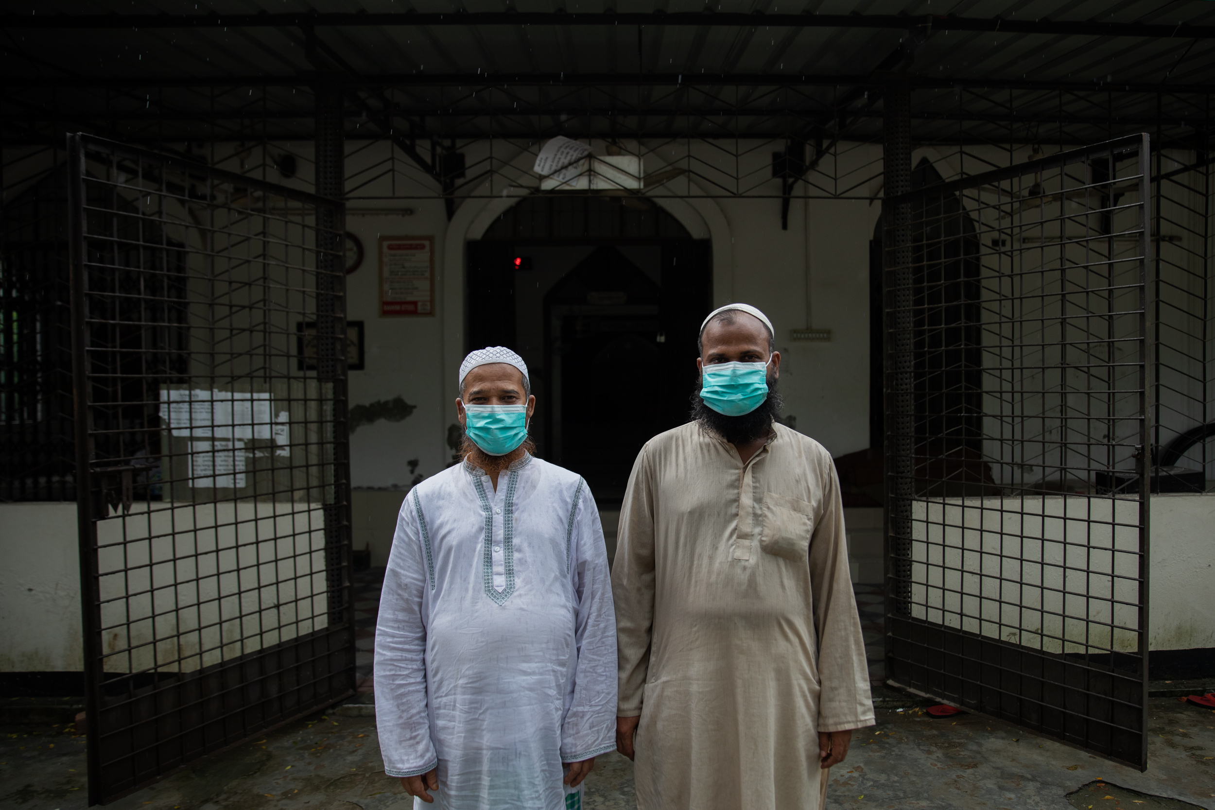 Local members pose in front of a Dhaka mosque wearing masks received from the Imam, Bangladesh. Photograph by and courtesy of Abdulla Al Kafi.