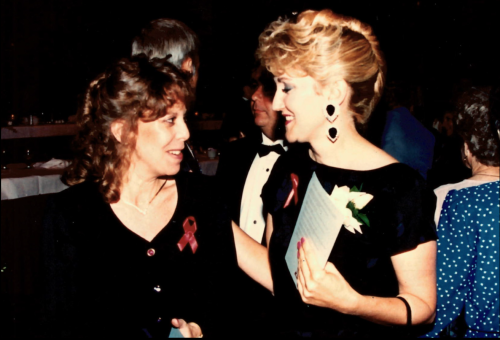 Ruth Burks, dressed in elegant attire, speaks with another attendee at the awards ceremony.